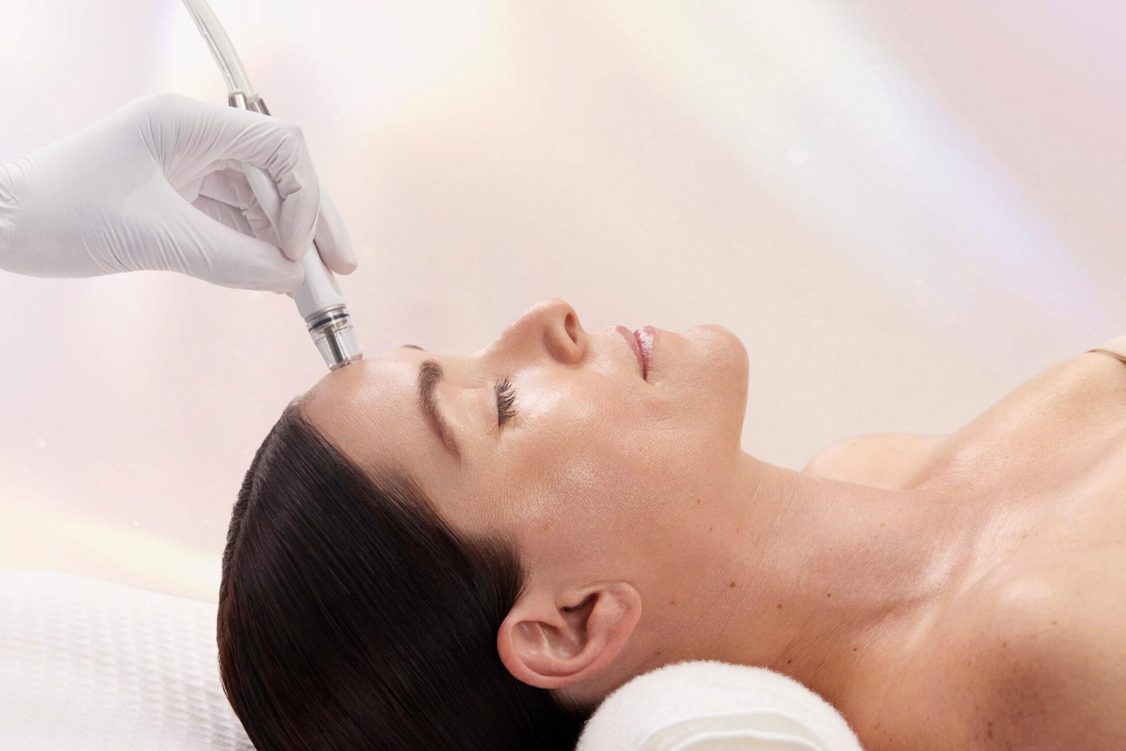 Patient receiving DiamondGlow facial for dull skin